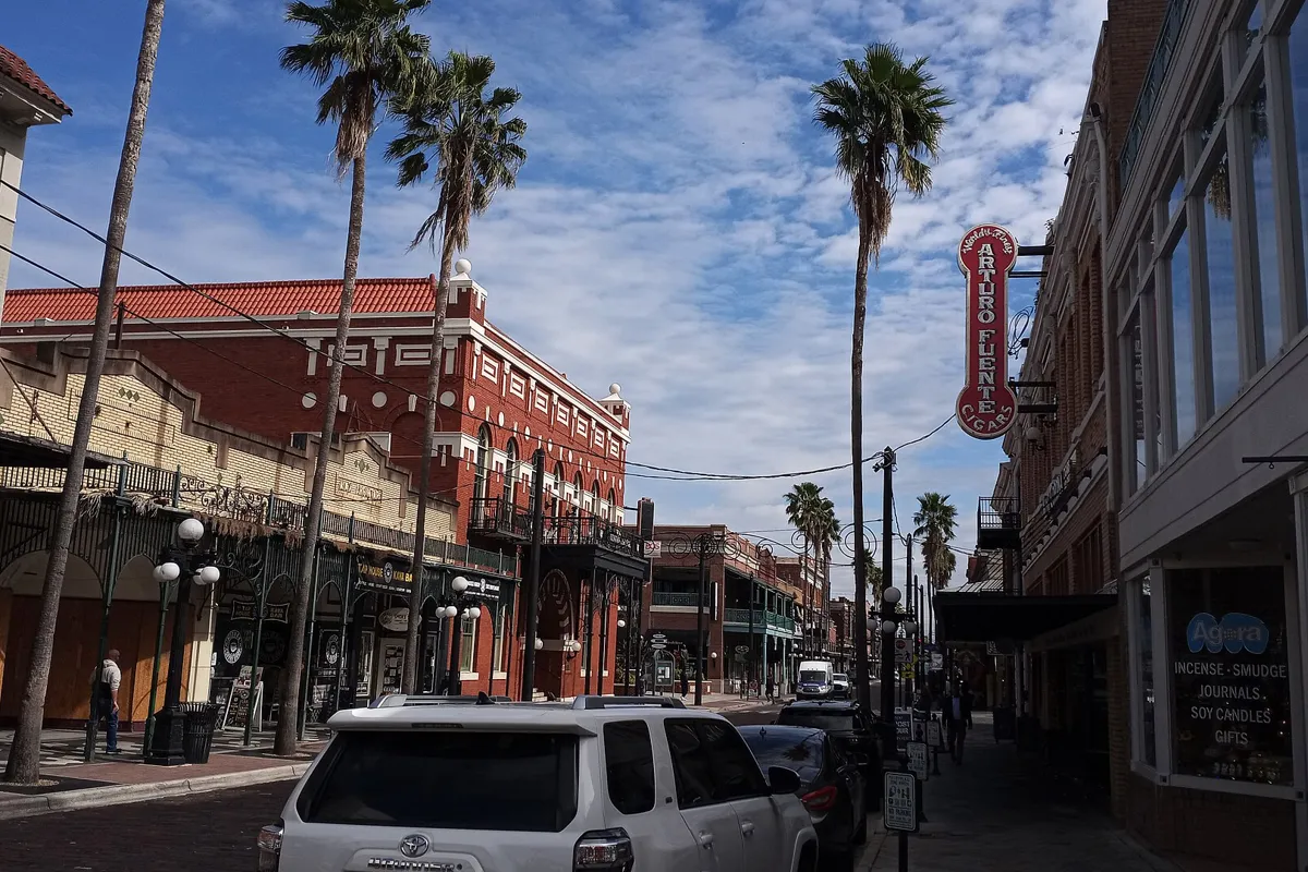 Brick buildings, palms and a vertical theater sign along 7th Avenue in Ybor City